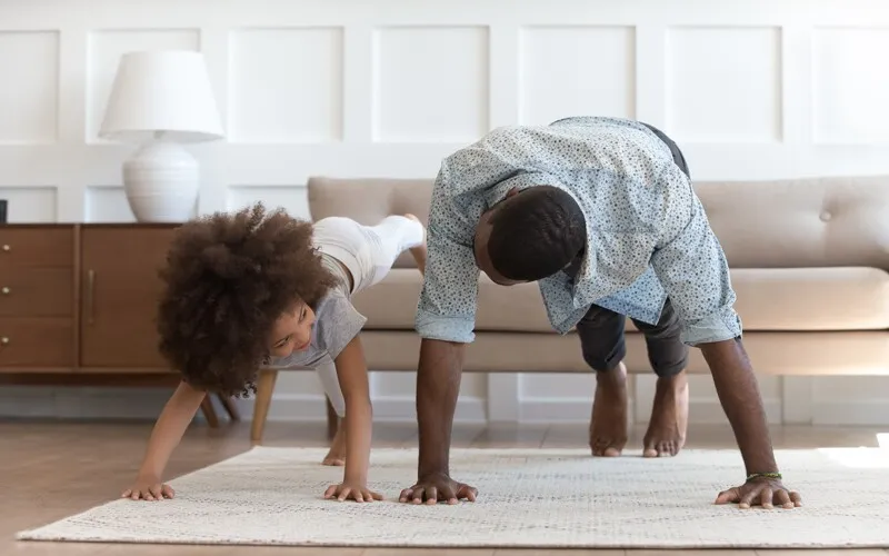 a father and daughter are productive by exercising at home